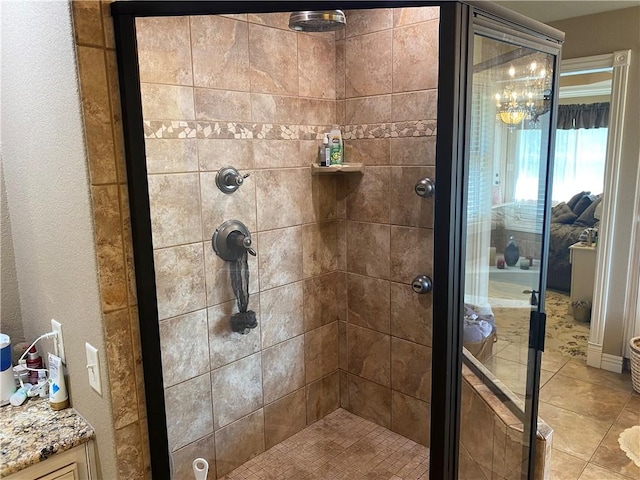 bathroom with tile patterned flooring and a shower stall