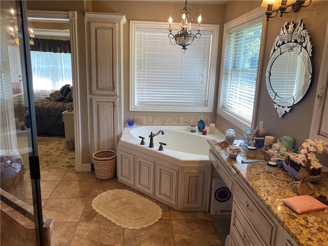 full bath featuring tile patterned floors, a chandelier, a bath, and vanity