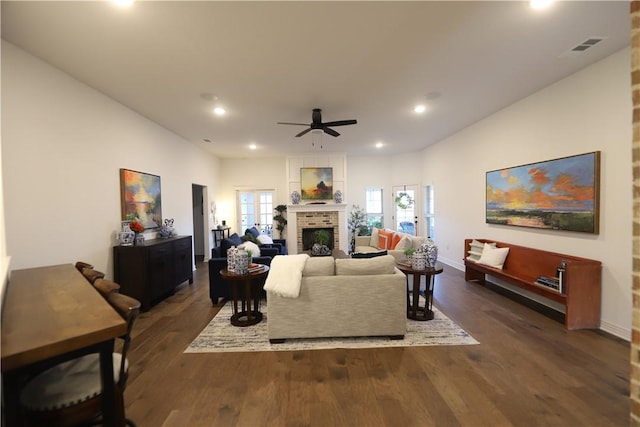 living area with visible vents, recessed lighting, a fireplace, ceiling fan, and dark wood-type flooring