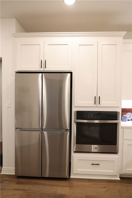 kitchen featuring white cabinets, dark wood-style flooring, and appliances with stainless steel finishes