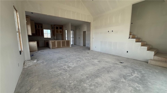 unfurnished living room with stairs