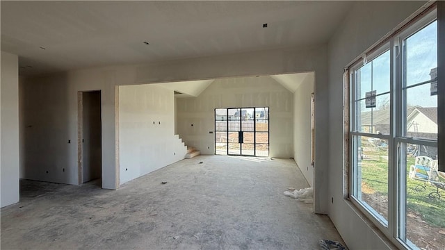 unfurnished room featuring stairway and plenty of natural light