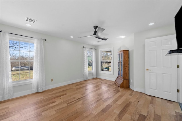 unfurnished living room with visible vents, a healthy amount of sunlight, baseboards, and light wood-style floors