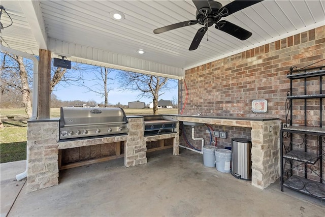 view of patio / terrace featuring area for grilling, an outdoor kitchen, and a ceiling fan