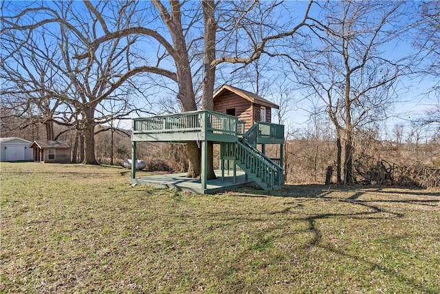 view of play area featuring stairway, a yard, and a wooden deck