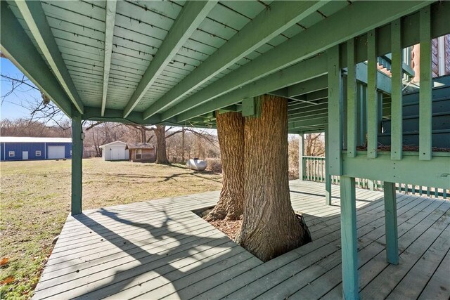 wooden terrace with a lawn and an outdoor structure