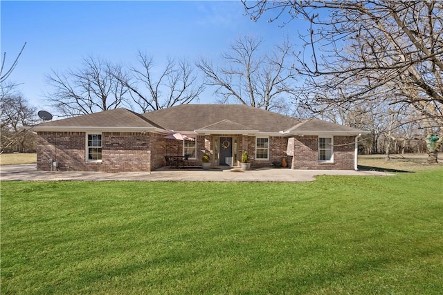 rear view of house with a yard and brick siding