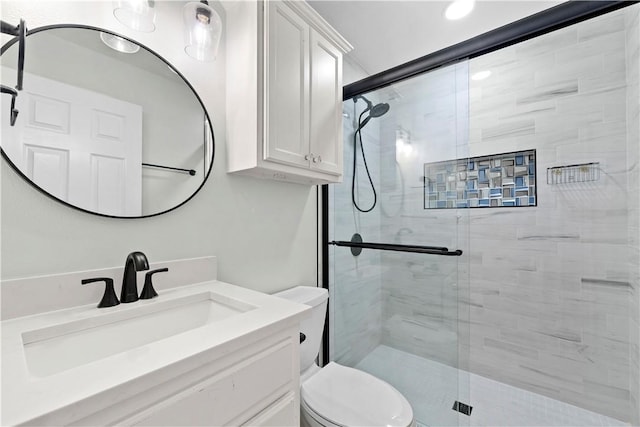 bathroom featuring vanity, toilet, and a stall shower