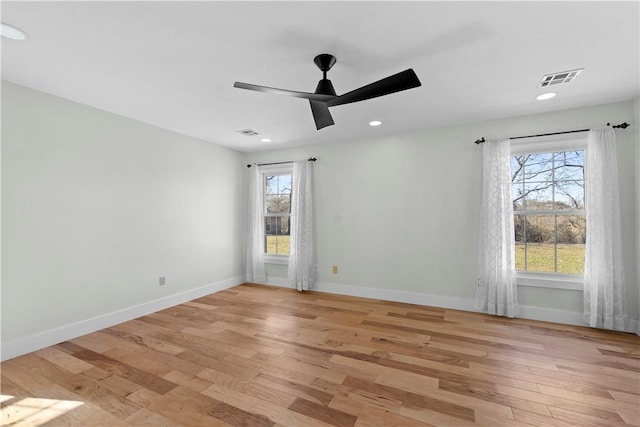 unfurnished room featuring visible vents, baseboards, and light wood-style floors