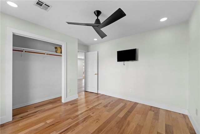 unfurnished bedroom with visible vents, baseboards, recessed lighting, wood finished floors, and a closet