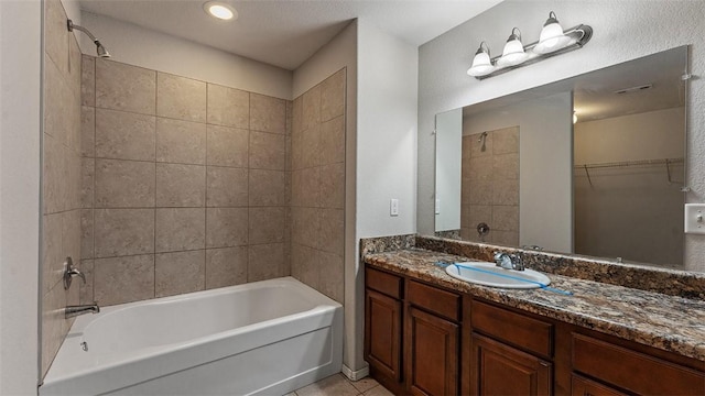 bathroom featuring a walk in closet, visible vents, shower / tub combination, tile patterned flooring, and vanity