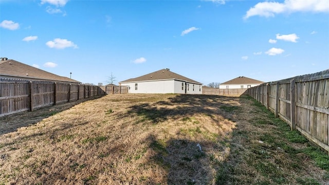 view of yard with a fenced backyard