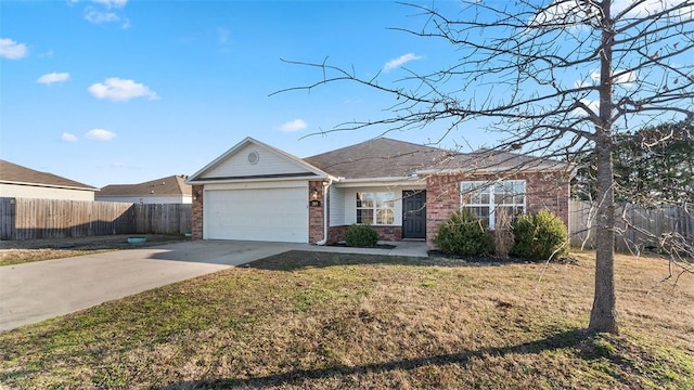 ranch-style home with driveway, fence, a front yard, an attached garage, and brick siding