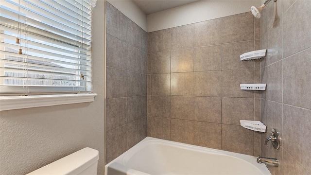 bathroom with toilet and bathtub / shower combination