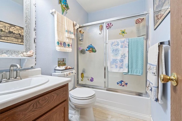 bathroom with bath / shower combo with glass door, vanity, and toilet