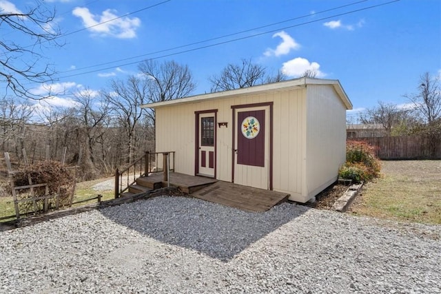 view of outbuilding with an outbuilding and fence