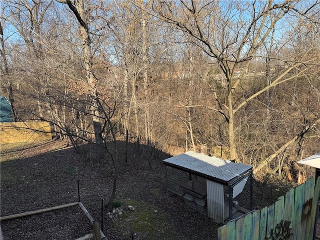 exterior space with an outbuilding and fence