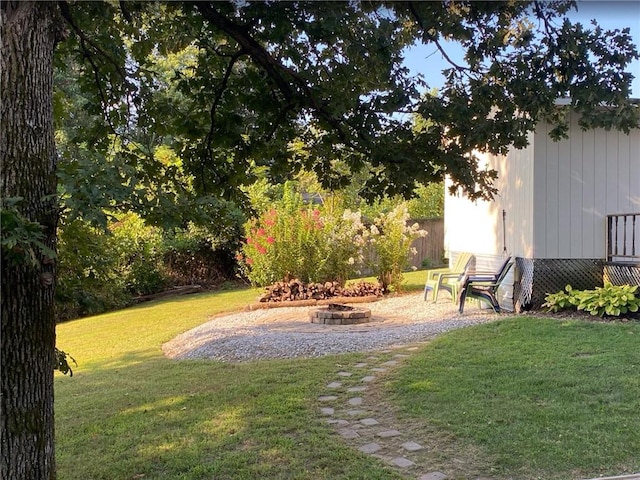 view of yard with a fire pit