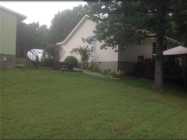 exterior space with crawl space and a lawn