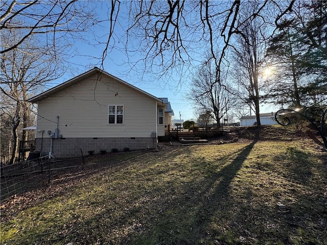 view of side of property featuring crawl space and a deck