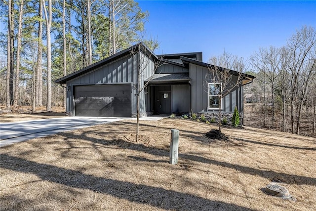 view of front of home with board and batten siding, concrete driveway, and a garage