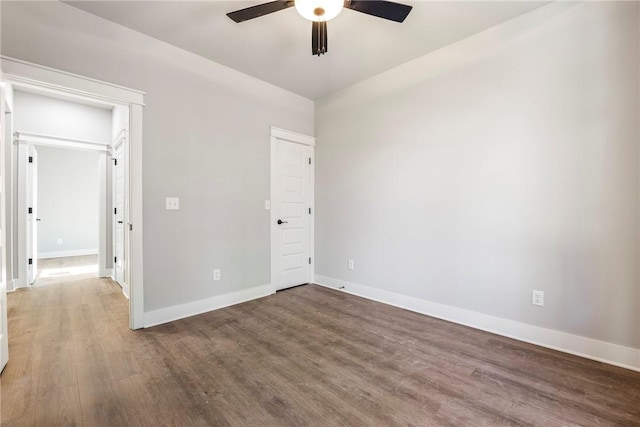 unfurnished bedroom with a ceiling fan, wood finished floors, and baseboards