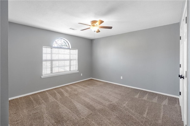 unfurnished room with visible vents, ceiling fan, baseboards, and carpet floors