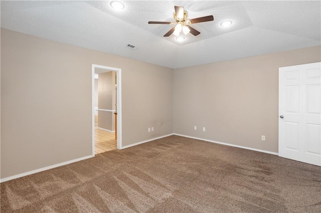 unfurnished room featuring visible vents, baseboards, carpet flooring, a textured ceiling, and a ceiling fan