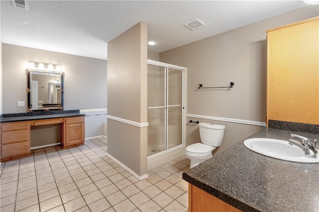 bathroom with tile patterned floors, visible vents, a shower stall, and vanity