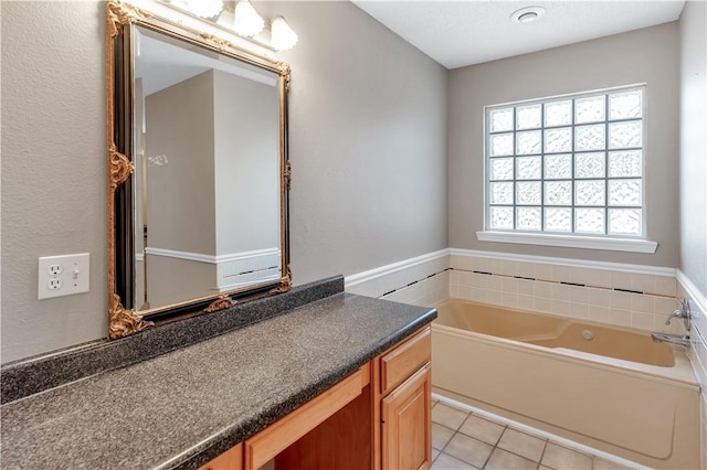 full bath featuring tile patterned flooring, a bath, and vanity