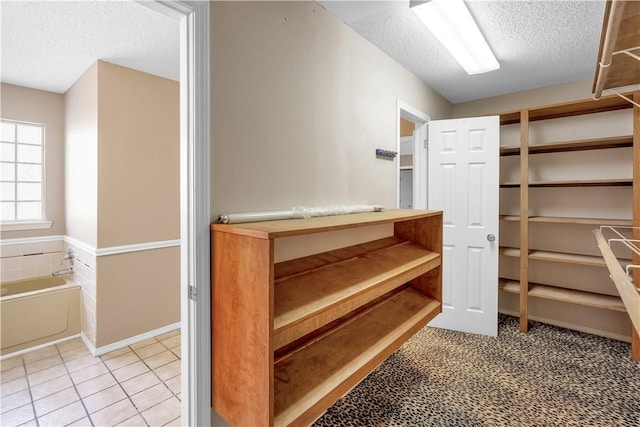 walk in closet featuring tile patterned flooring