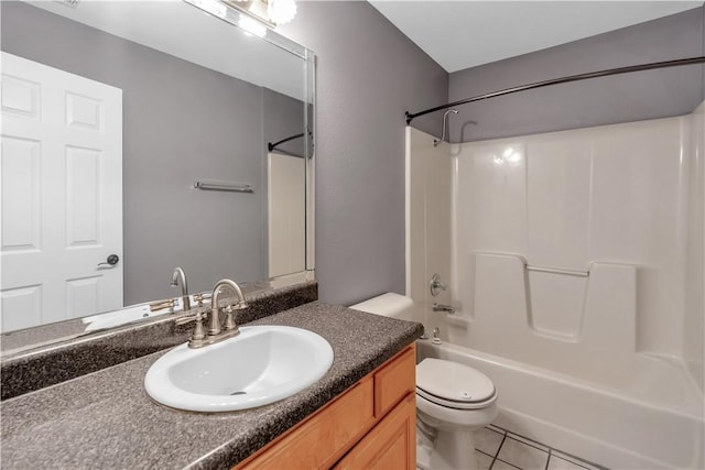 bathroom with tile patterned floors, vanity, toilet, and shower / bathtub combination