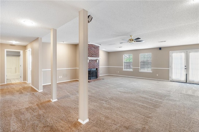 5530 Blake Ln, Springdale, AR 72762 - unfurnished living room with a textured ceiling, carpet floors, ceiling fan, a brick fireplace, and baseboards