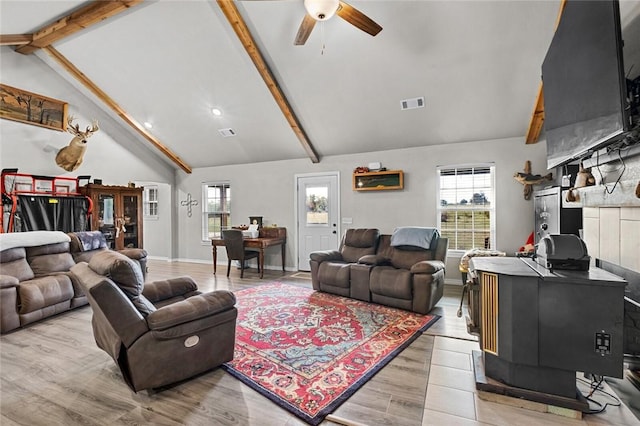 living room with baseboards, visible vents, beam ceiling, ceiling fan, and light wood-style floors