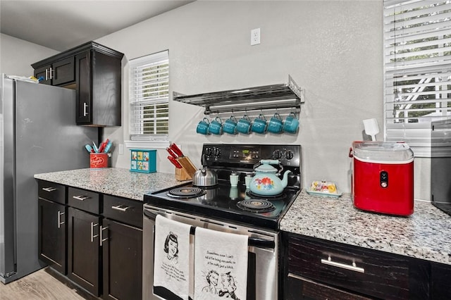 kitchen featuring light stone counters and appliances with stainless steel finishes