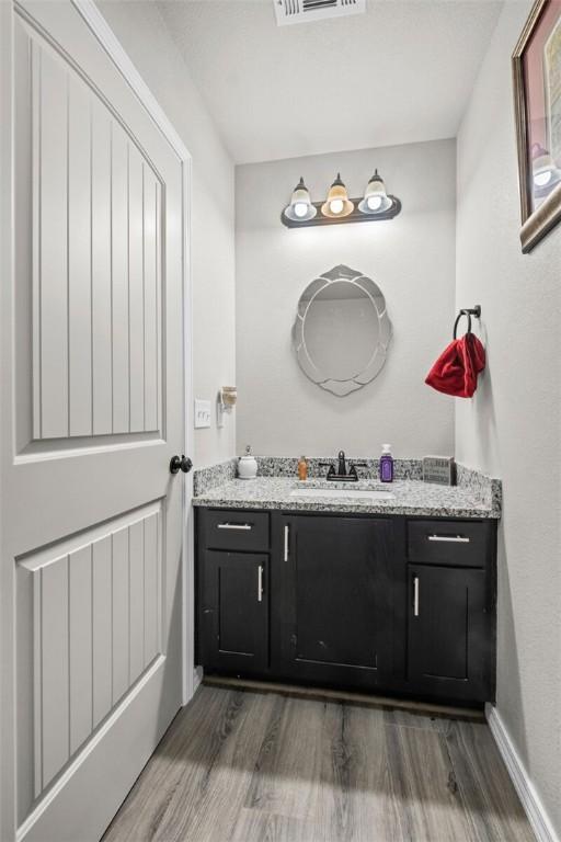 bathroom featuring vanity, wood finished floors, and visible vents