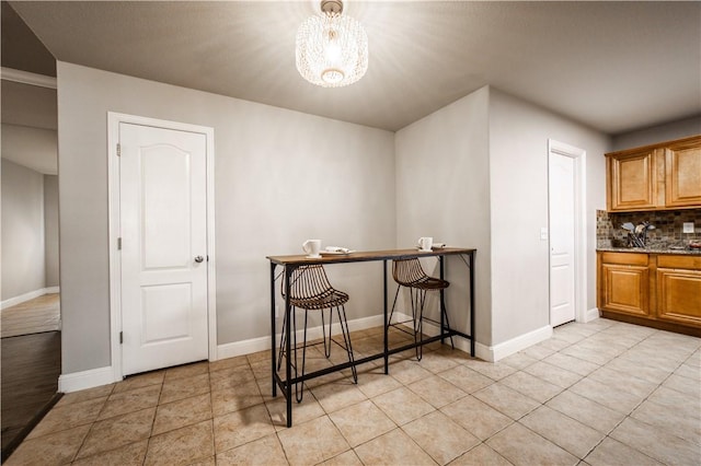 dining area with light tile patterned floors and baseboards