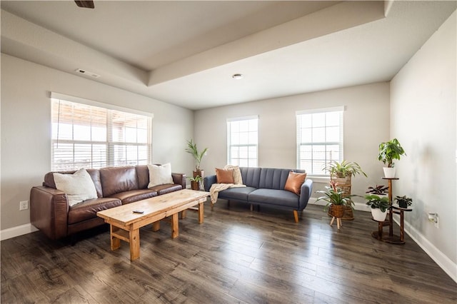 living room featuring a tray ceiling, visible vents, dark wood-style flooring, and baseboards