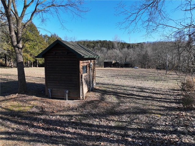 view of shed featuring a forest view