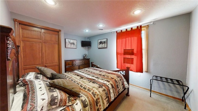 bedroom with recessed lighting, baseboards, light carpet, and a textured ceiling