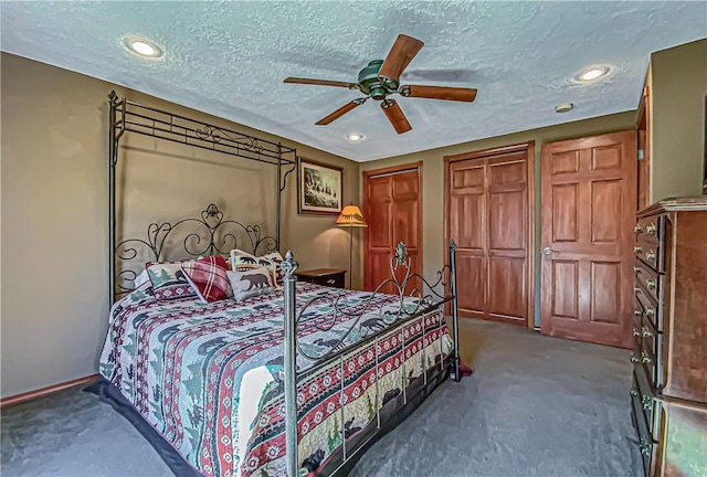 carpeted bedroom featuring recessed lighting, multiple closets, a textured ceiling, and a ceiling fan