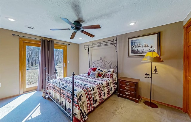 bedroom featuring access to exterior, baseboards, visible vents, and a textured ceiling