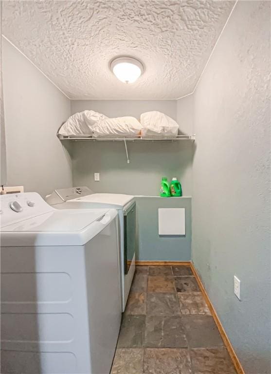 725 County Road 455, Berryville, AR 72616 - washroom with separate washer and dryer, stone finish flooring, and a textured ceiling