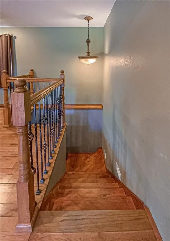 stairway with wood finished floors