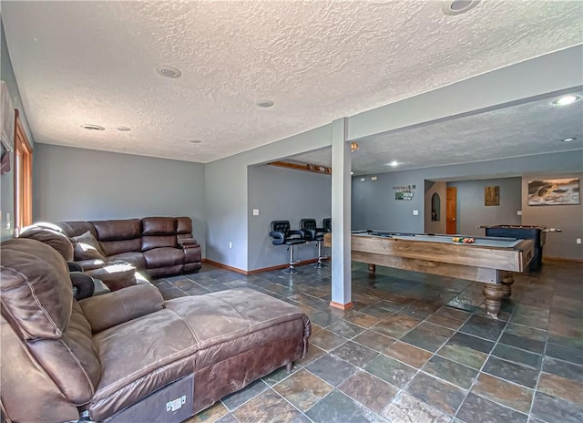 living room with stone finish flooring, a textured ceiling, arched walkways, pool table, and baseboards