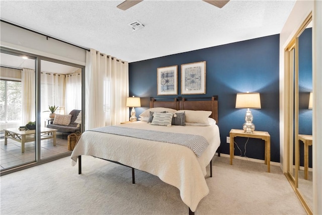 bedroom featuring visible vents, access to outside, a textured ceiling, carpet floors, and baseboards