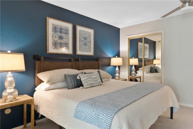 bedroom with a closet, baseboards, and carpet flooring