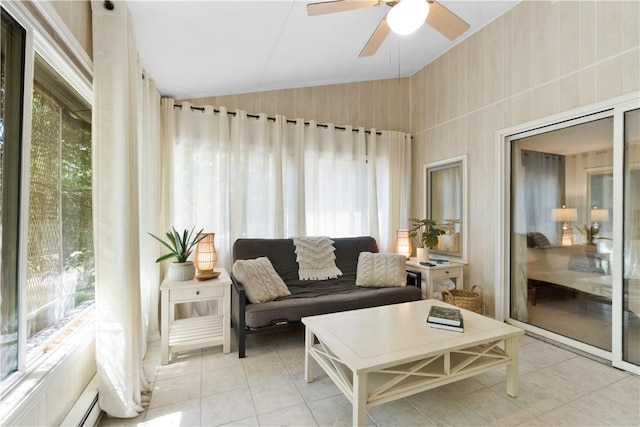 sunroom / solarium featuring plenty of natural light, ceiling fan, baseboard heating, and lofted ceiling