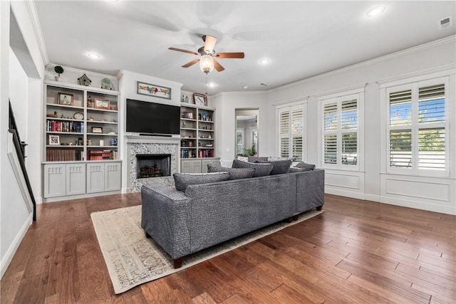 living room featuring recessed lighting, a fireplace, dark wood-style flooring, ceiling fan, and ornamental molding