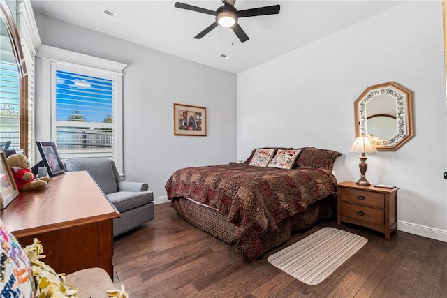 bedroom with visible vents, baseboards, wood finished floors, and a ceiling fan